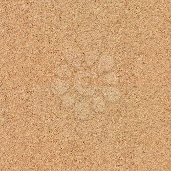 Flat yellow sand surface textured background close-up view
