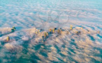 Aerial view of Doha through the morning fog, the capital of Qatar in the Persian Gulf