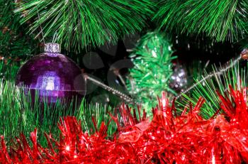 Shabby ball and tinsel on artificial Christmas tree