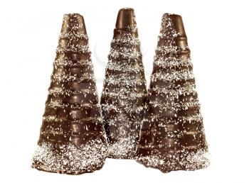Three chocolate cone in the form a snowy trees isolated on a white background
