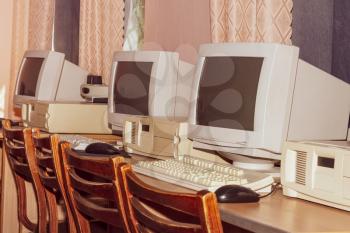 A stylized classic film image of a room with old computers