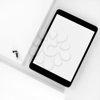 Blank tablet pc on white paper background. Mockup for design presentations and portfolios. Top view.