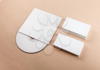 Business cards and compact disk on color background.