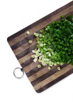 Green chopped onions on a cutting board. Clipping path.