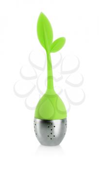 Tea infuser with metallic container and green rubber handle with leaves isolated on white background.
