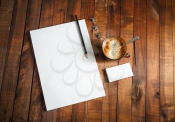 Photo of blank stationery template. Letterhead, business cards, coffee cup and pencil. Mock-up for design presentations and portfolios. Top view.