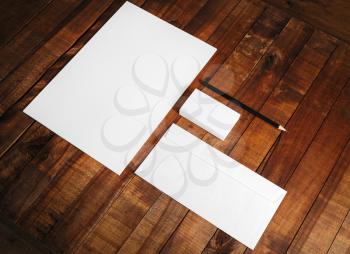 Photo of blank stationery set. Blank corporate identity template on wooden table background. Mock-up for design presentations and portfolios.