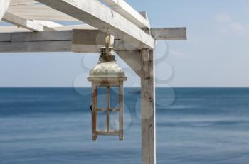 Painted Wooden lantern on a background of the sea.