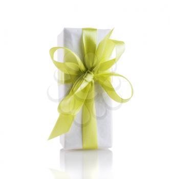 Festive gift box with yellow-green satin ribbon tied in a bow. Isolated with clipping path.