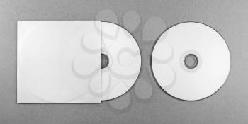 Blank CD on gray background. Mock-up for design presentations and portfolios. Top view. Grayscale image.