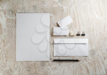 Blank stationery set on light wooden background. Template for ID.