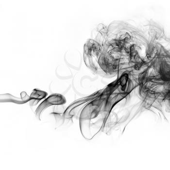 Black smoke swirls on white background. Studio shot.