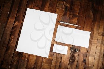 Blank stationery set on wooden table background. Blank paperwork template for design presentations and portfolios. Mock up for branding identity. Top view.