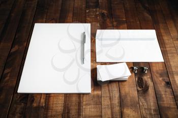 Blank stationery set on wooden table background. ID template. Mock up for branding identity for design presentations and portfolios. Blank letterhead, business cards, envelope and pen.