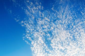 Blue sky with white tiny clouds. Natural background.