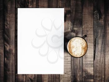 Blank letterhead and coffee cup on vintage wooden table background. Blank branding template. Blank stationery. Mockup for branding identity for placing your design. Top view.. Top view.