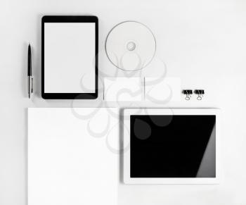 Photo of blank stationery set on white paper background. Responsive design template. Blank branding mock up. Blank objects for placing your design. Top view.