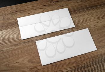 Blank envelopes on wooden table background. Front and back side.