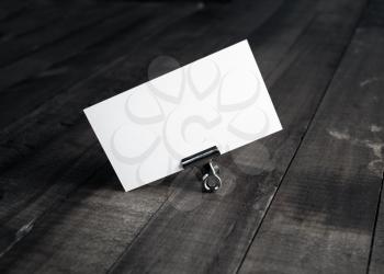 Photo of blank white bussiness card on wood background. Mockup for ID. Template for promotion of corporate identity. Blank name card.