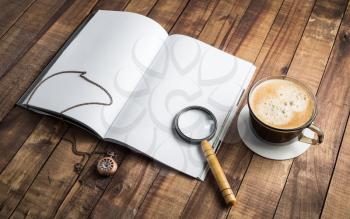 Photo of blank opened book, magnifier, vintage clock and coffee cup on wooden background. Stationery elements. Template for placing your design. Responsive design mockup.
