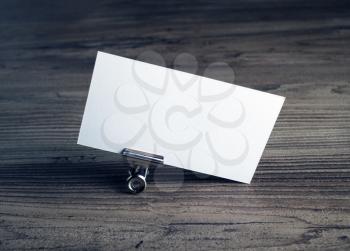 Photo of blank business card on wooden table background. Blank template for ID. Mockup for branding identity.