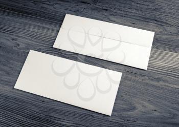 Two blank envelopes on wood background. Front and back side.