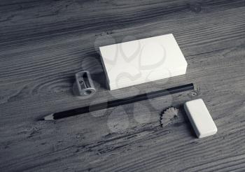 Photo of blank stationery set. ID template. Mockup for branding identity. Bank business cards, pencil, eraser, flash drive and sharpener on wooden table background.
