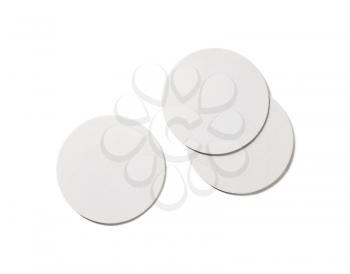 Photo of blank beer coasters on white background. Isolated with clipping path. Flat lay.