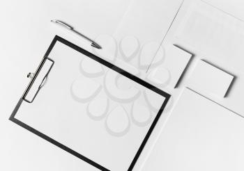 Photo of blank corporate stationery set with plenty of copy space on white paper background. Top view. Flat lay.