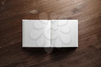 Open book, brochure or notebook with blank pages on wood table background. Flat lay.