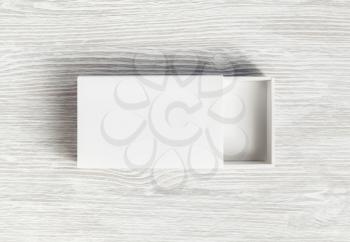 Blank box mock up. White paper box on light wood table background. Branding mockup. Flat lay.