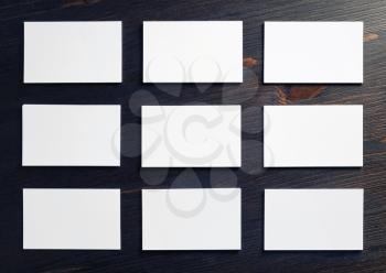 Many blank business cards on wood table background. Copy space for text. Flat lay.
