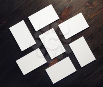 Photo of blank business cards on wood table background. Template for ID. Copy space for text. Flat lay.