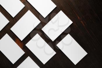 Many blank business cards on wooden background. Template for branding identity. Flat lay.