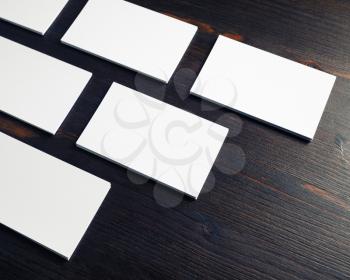 Blank white business cards on wooden background. Mock-up for branding ID.