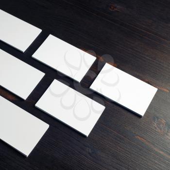 Blank white business cards on wooden background. Copy space for text.