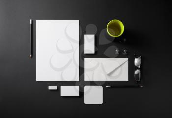 Photo of blank stationery set on black background. Template for branding identity for designers. Top view.