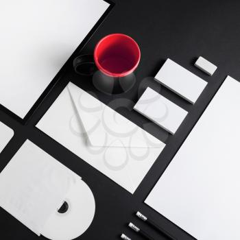 Brand identity template. Photo of blank corporate stationery set on black background.