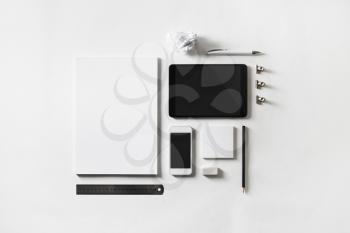 Photo of blank stationery and gadgets set at white paper background. Brand identity mockup. Flat lay.