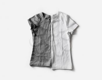 Two blank white and gray t-shirts. Tshirt mockup for placing your design or logo. Flat lay.