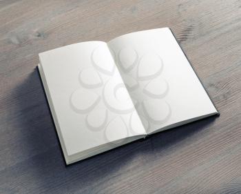 Blank opened notebook on wooden background. Template for graphic designers portfolios.