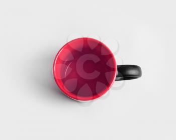 Blank ceramic black and red mug or cup for coffee or tea.