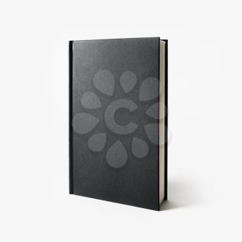 Blank black vertical book cover on white paper background.