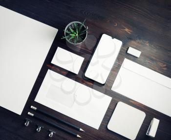 Blank corporate stationery template on wood table background. Responsive design mockup.