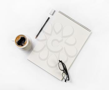 Sketchbook, glasses, coffee cup, pencil and eraser. Blank stationery template Flat lay