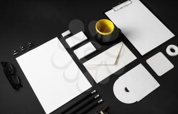 Blank corporate identity template on black paper background. Photo of blank stationery set. Mockup for design presentations and portfolios.