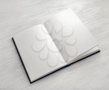 Mockup of opened blank booklet on light wooden background.