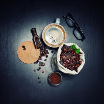 Delicious fresh coffee composition on black wooden background. Flat lay.