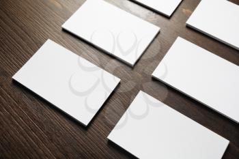 Photo of blank business cards on wooden background. Template for branding identity.