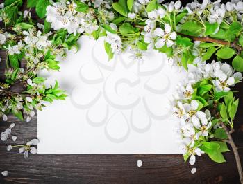 Mock up poster with spring flowers on wood table background. Flat lay.